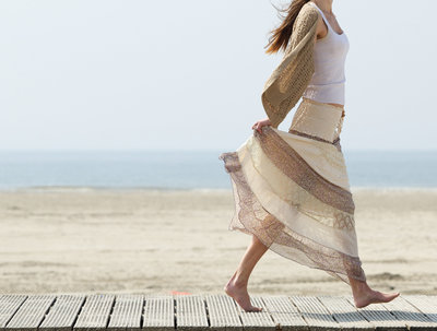 female-walking-at-the-beach-barefoot-with-dress-PJD4RW6