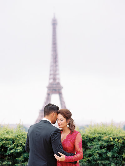 Couple embraces in front of Eiffel Tower during Paris anniversary photography session