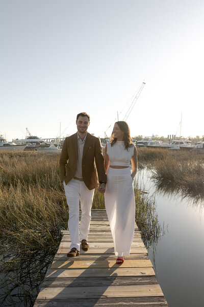 Charleston Engagement photo taken at the battery . Couple kissing with sun in background