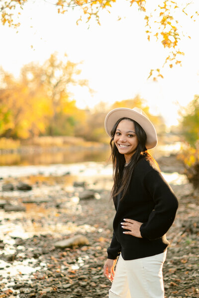 Girl in white dress holding a bouquet for her cottagecore high school senior portraits