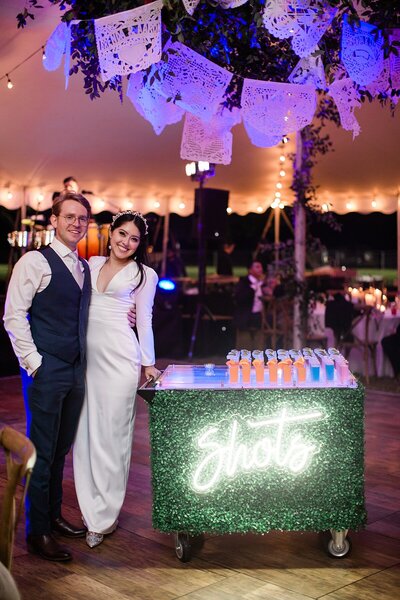 couple stand with shot cart on dance floor