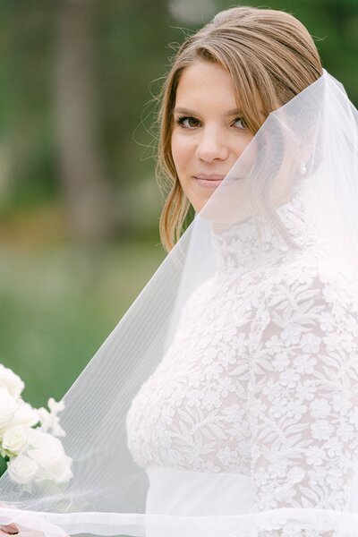 Bride peeking around her veil