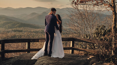 Couple dancing with mountains in the background on their wedding day