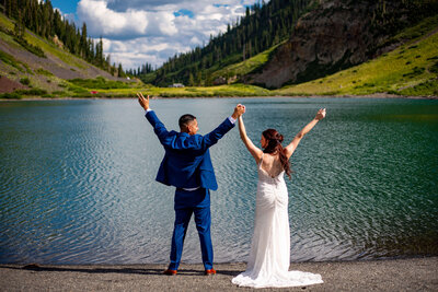 A newly wed couple enjoys a beautiful Colorado sunset as the sun slips behind the mountains
