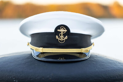 Midshipman Cover and Fall foliage at US Naval Academy sea wall overlooking Chesapeake bay.