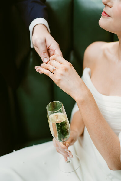 Bride with champagne glass by Cincinnati wedding planners Love and Whimsy Events.