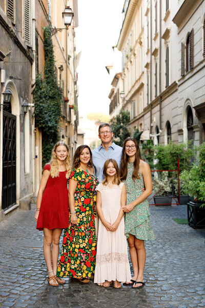 A family of five on the cobblestoned streets of Monti. Rome Photographer, Taken by Rome Photographer, Tricia Anne Photography.