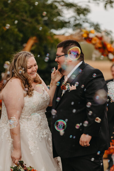 post ceremony bubbles surrounding bride and groom