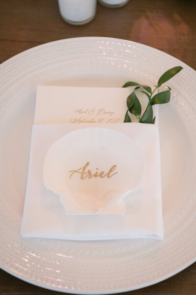 Scallop shell place card with gold calligraphy