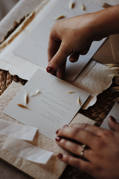 Wedding invitation designer arranging white invitations