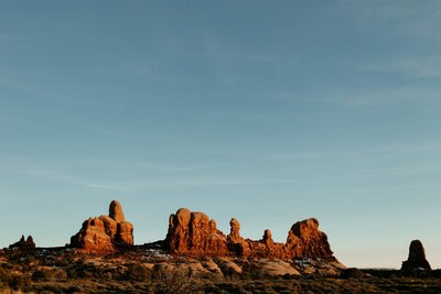 Marching elephants at Arches National Park taken by destination elopement photographer during sunset in Moab Utah