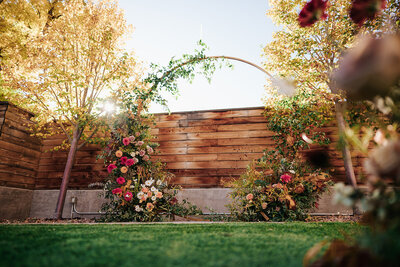 Circular floral arch for fall courtyard wedding in Colorado