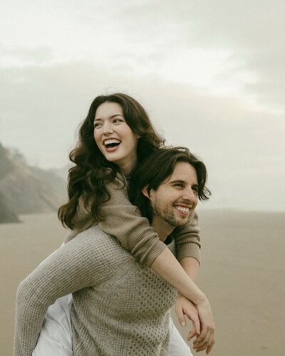 Couple laughing on oregon beach