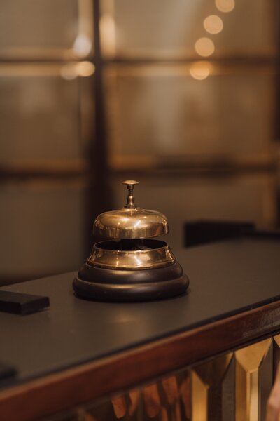 A brass ring for service bell sits on a counter.