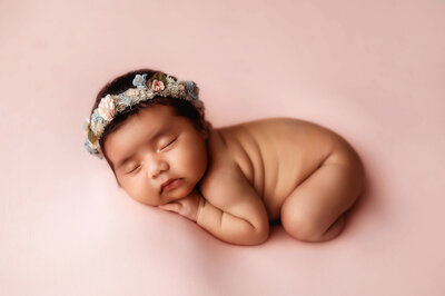 Newborn baby posed in a basket for Newborn Photos in Asheville.