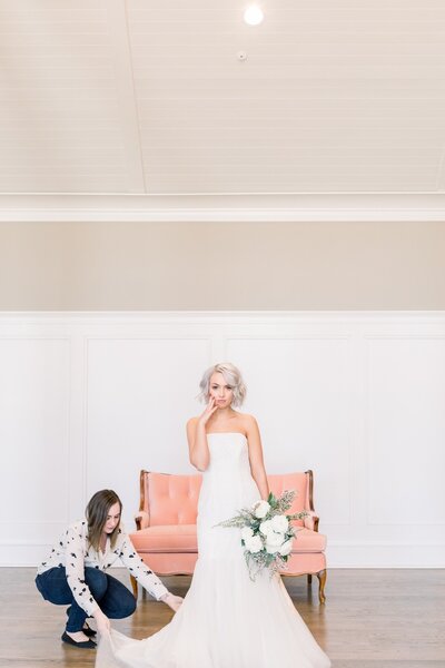 Tulsa wedding planning expert | Bethany Faber Events helping a bride fix her dress!
