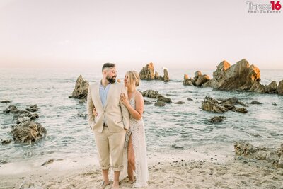 Future Bride and Groom share a kiss on the sands of Little Corona del Mar Beach