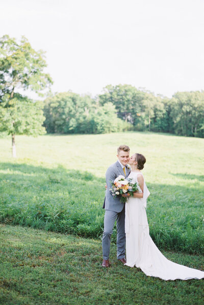 photo of a couple in a field at wedding