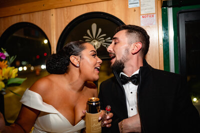 Bride and groom sing and drink beer in a trolley