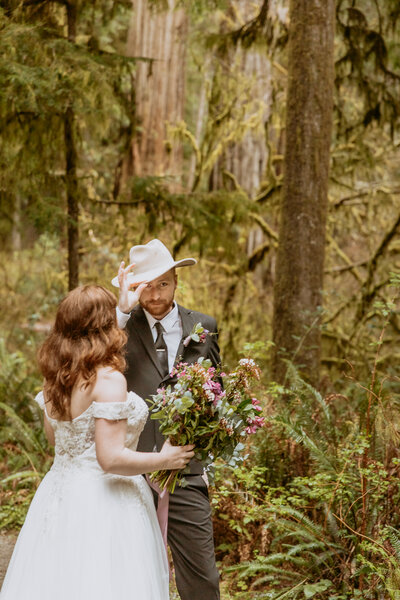 photo of groom wearing bride's hat at their destination elopement