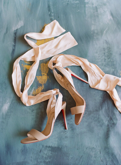 Blue background, cream Christian Louboutinshoes