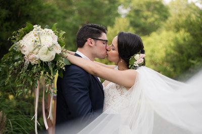 bride and groom kiss at jasmine plantation wedding in williamsburg virginia