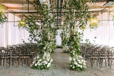 Green and white florals ceremony setup