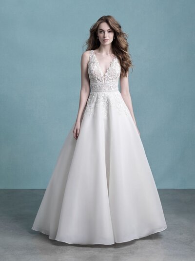The smooth overlay of this gown's full skirt is a beautiful contrast to the soft, dimensional appliques along the bodice.