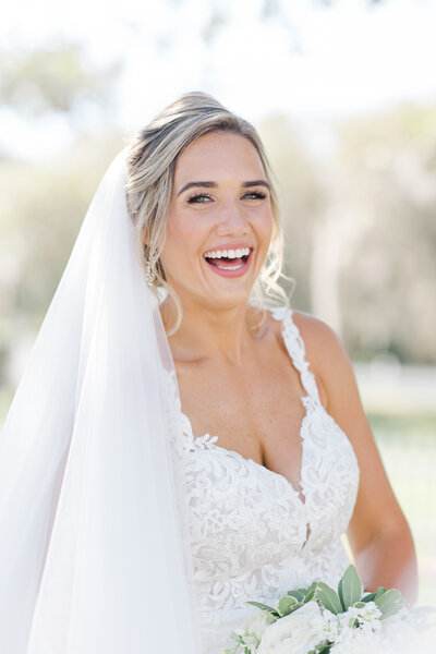 bride smiling in her dress and veil