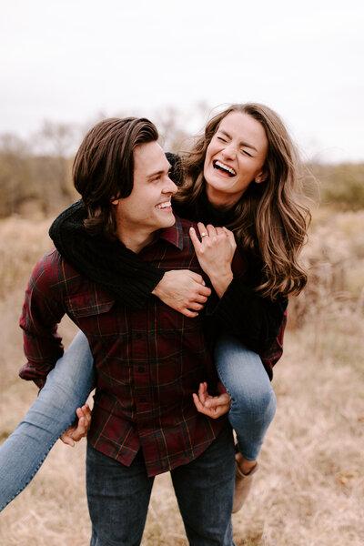 couple piggy back ride laughing photo