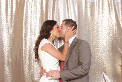 bride and groom kissing in photo booth