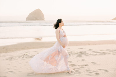 Mom in white dress in portland rose garden park for maternity photography captured by Ann Marshall Photography