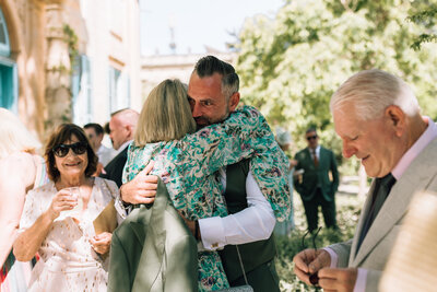 groom embraces guest
