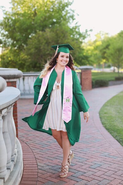 girl smiling wearing graduation cap and gown