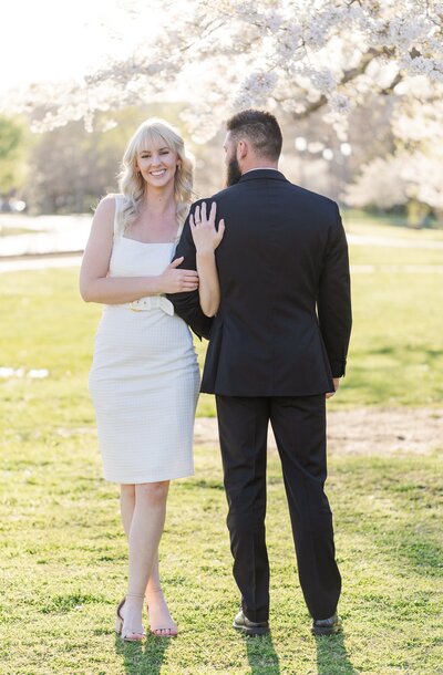 couple posing together during their Nashville Parthenon Engagement Session during spring when the cherry blossoms bloom