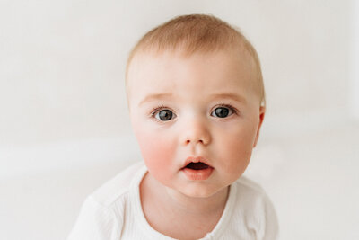 Newborn Baby Boy being kissed by parents on a newborn photoshoot in Cheshire