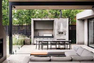 Modern industrial outdoor space with exposed steel elements and concrete features.
