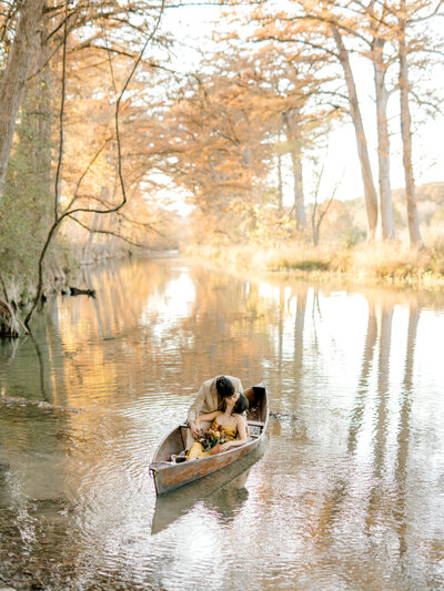 fall engagement couple in canoe