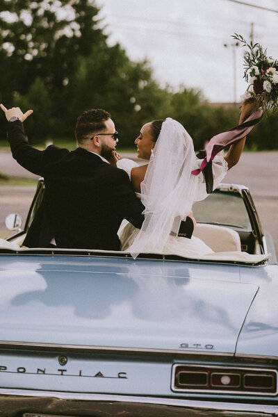 couple posing in car captured by an lgbt photographer