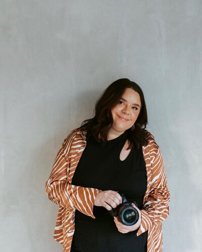 woman smiling holding a camera