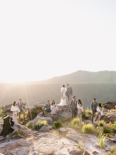 Wedding party portrait in mountains at sunset