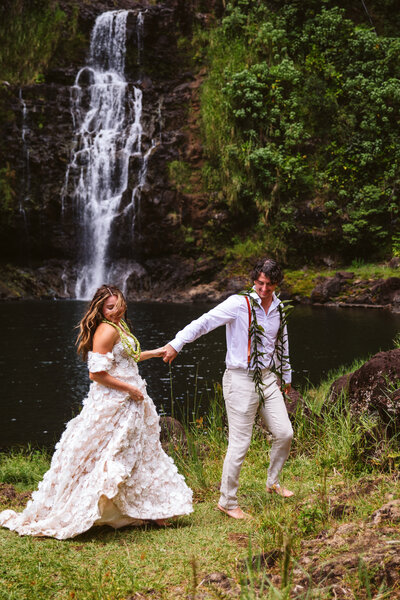Elopement couple standing by a waterfall - The Big Island, Hawaii