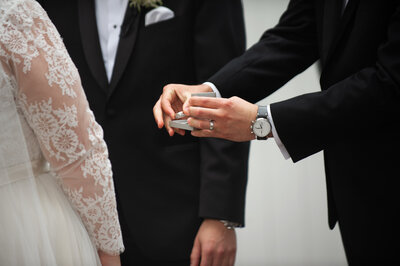 A person pulling a wedding ring out of a box