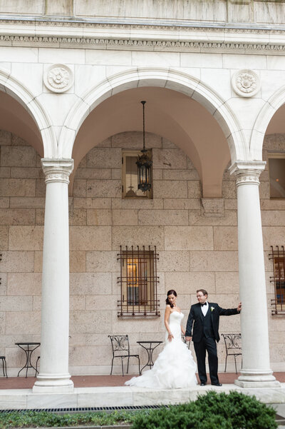 couple posing in courtyard at boston public library