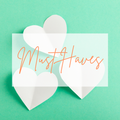 White paper hearts on a bright green background, with the words "Must-Haves"