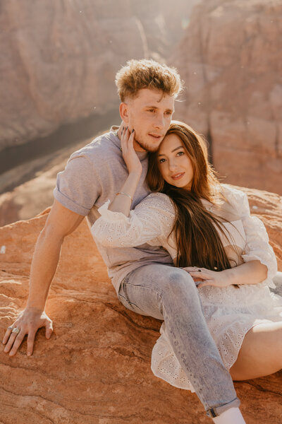 couple sit on cliff