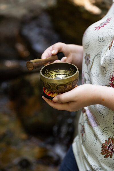 A therapist hits a sound bowl during her personal branding session in Baltimore County, Maryland