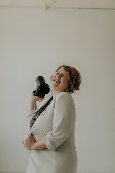 Candid photo of Seattle wedding photographer, Marnie Cornell, laughing