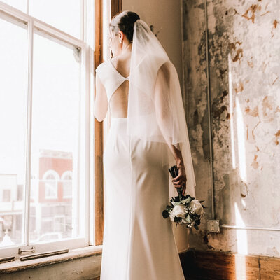 View Of  Bride Looking Out Window Of Kansas Wedding Venue