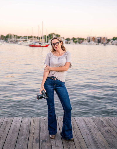 Kelly Eskelsen Photography smiles in Downtown Annapolis City Dock at Sunset with boats.